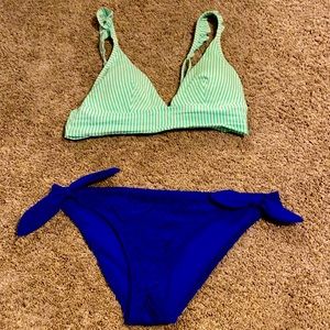 Green and white striped top with blue bottoms